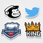 Various shapes and sizes of custom die cut stickers displayed in a professional setting.